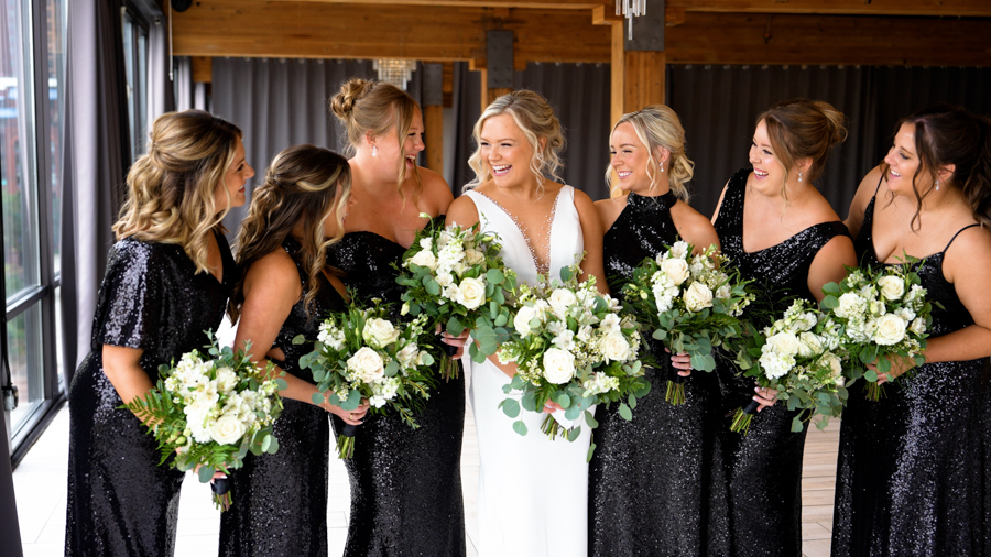 a group of women in black dresses