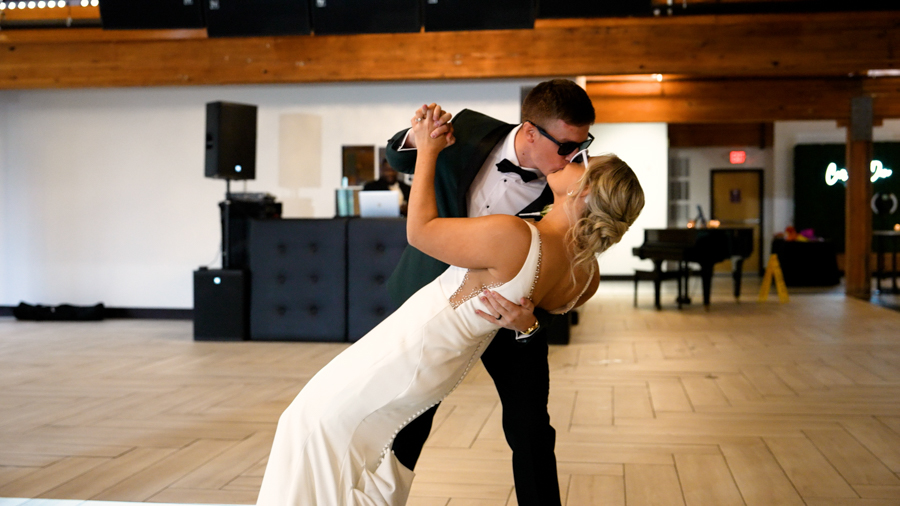 a man and woman kissing in a room